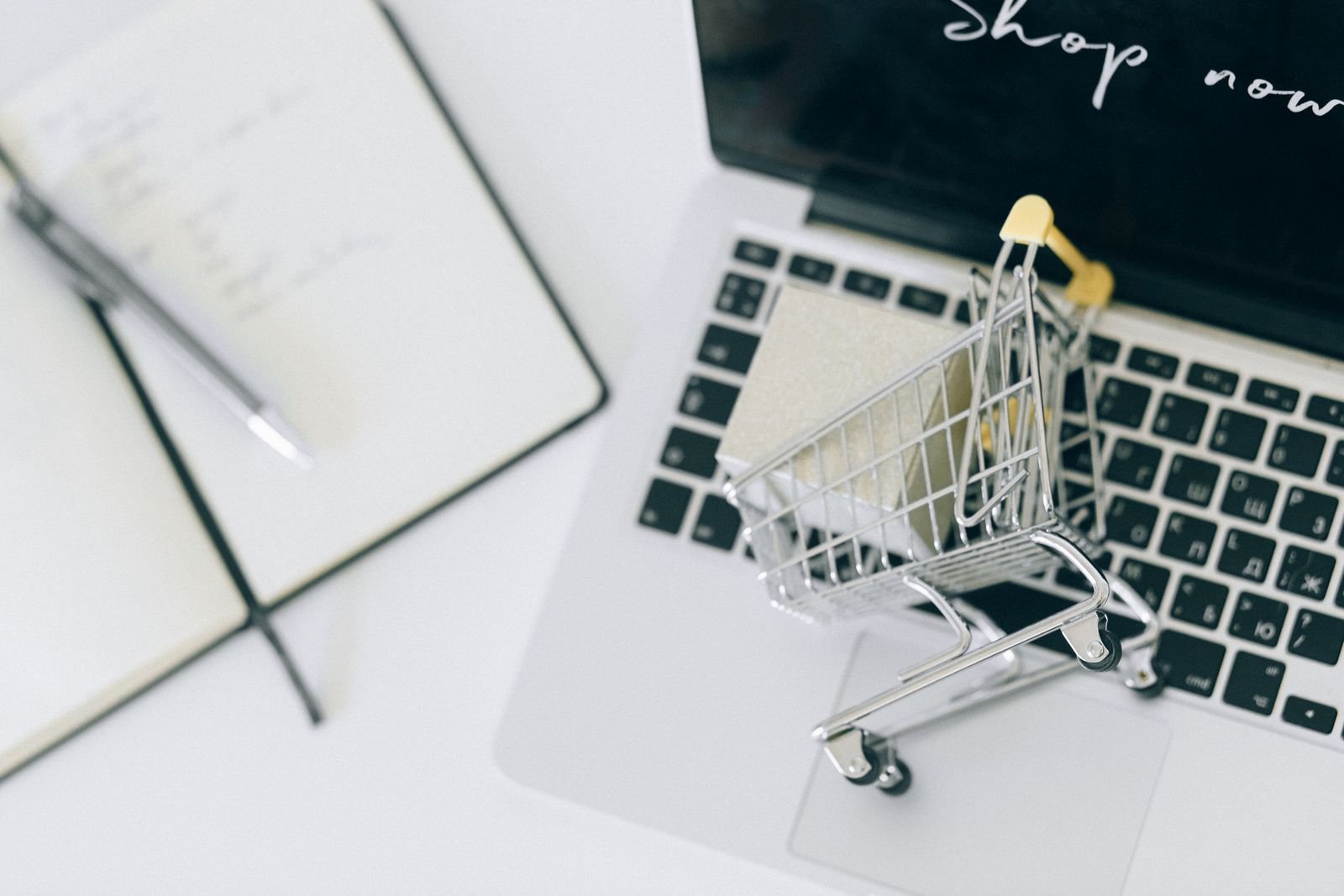 Online shopping cart next to a laptop