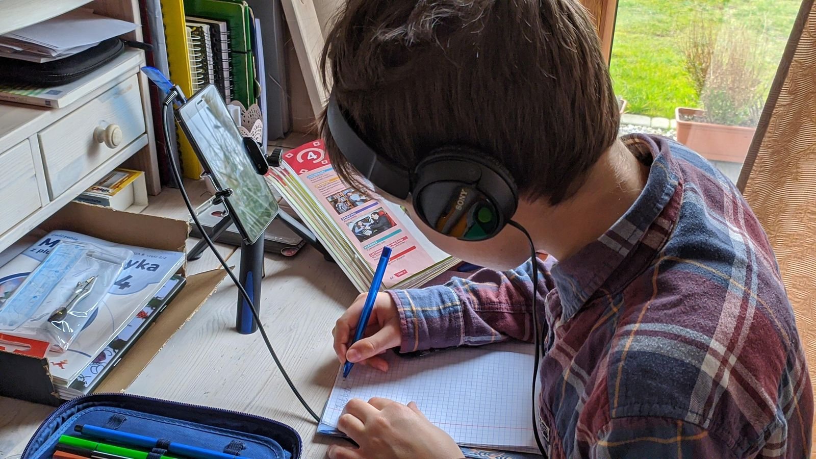 Student learning online with headphones and a laptop
