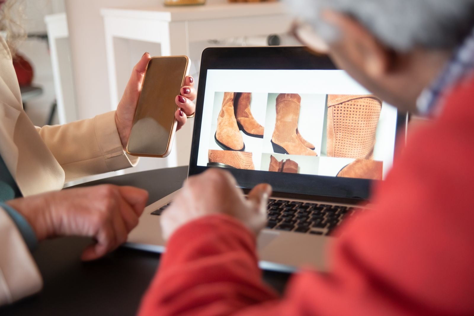 Buyer browsing products on a phone and laptop